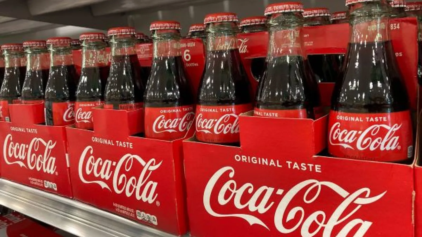 Coca Cola bottles on a shelf