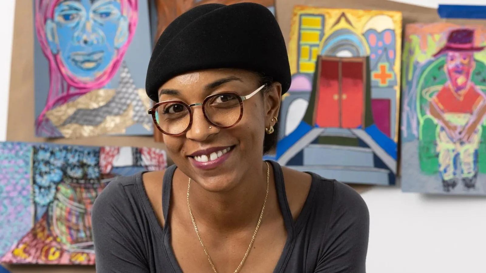 Tiffany Lawson smiles in front of her colorful art