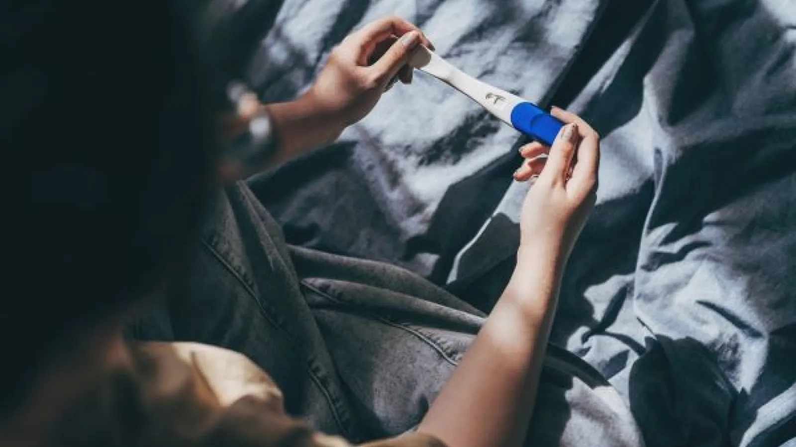 a person holding a pregnancy test