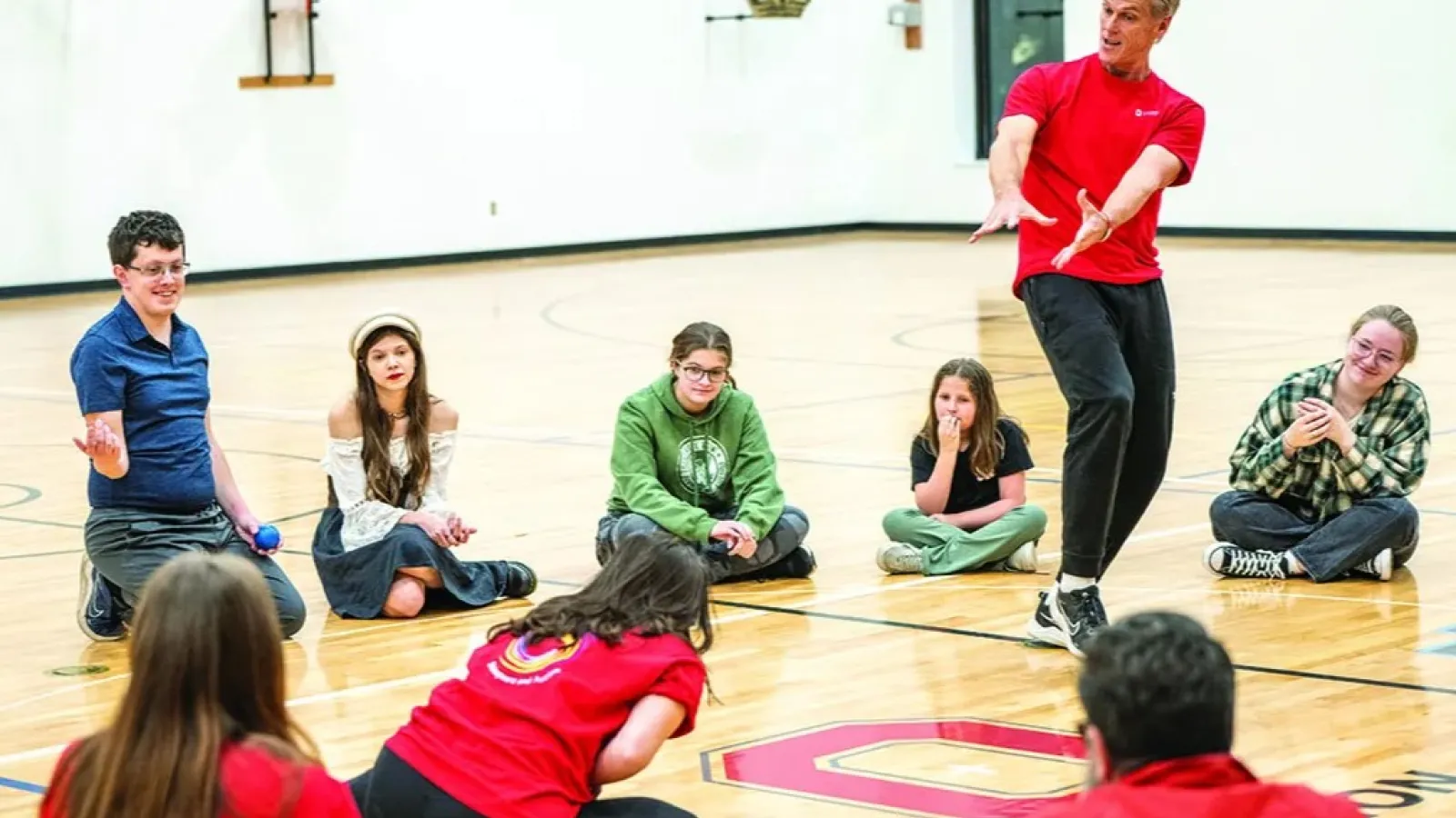 Kevin McClatchy works with students as part of a movement class