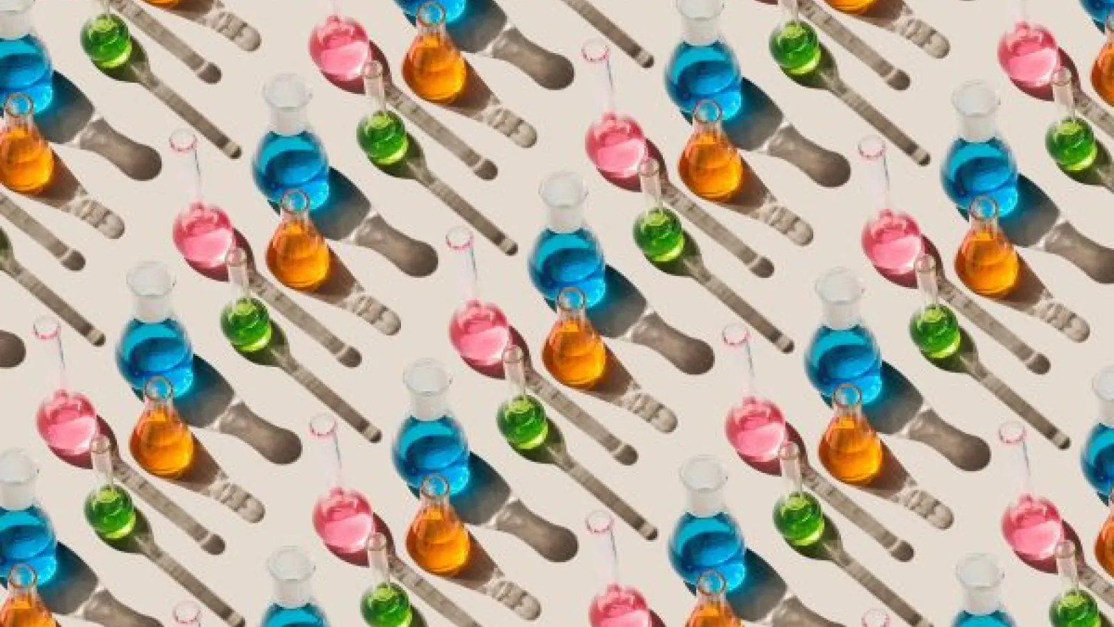 flasks full of colorful liquids arranged in a stripe pattern