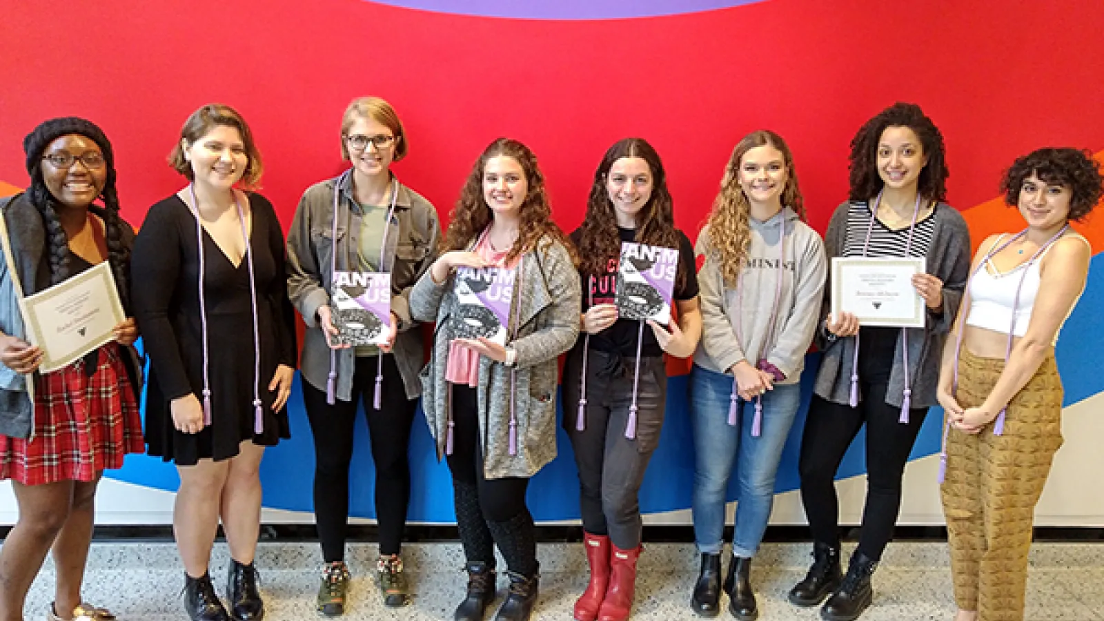Students holding Triota journal