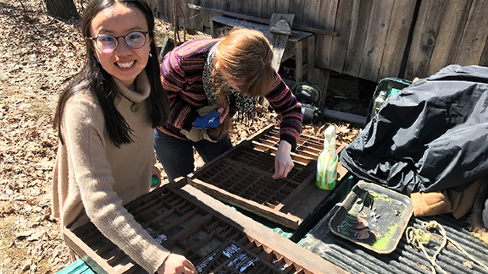 Luna Luo (left) and Molly Rideout (right), students from the 2018 Ohio Field School class, clean and sort type for their service project, which involved assisting with the restoration of Bloody Twin Press.