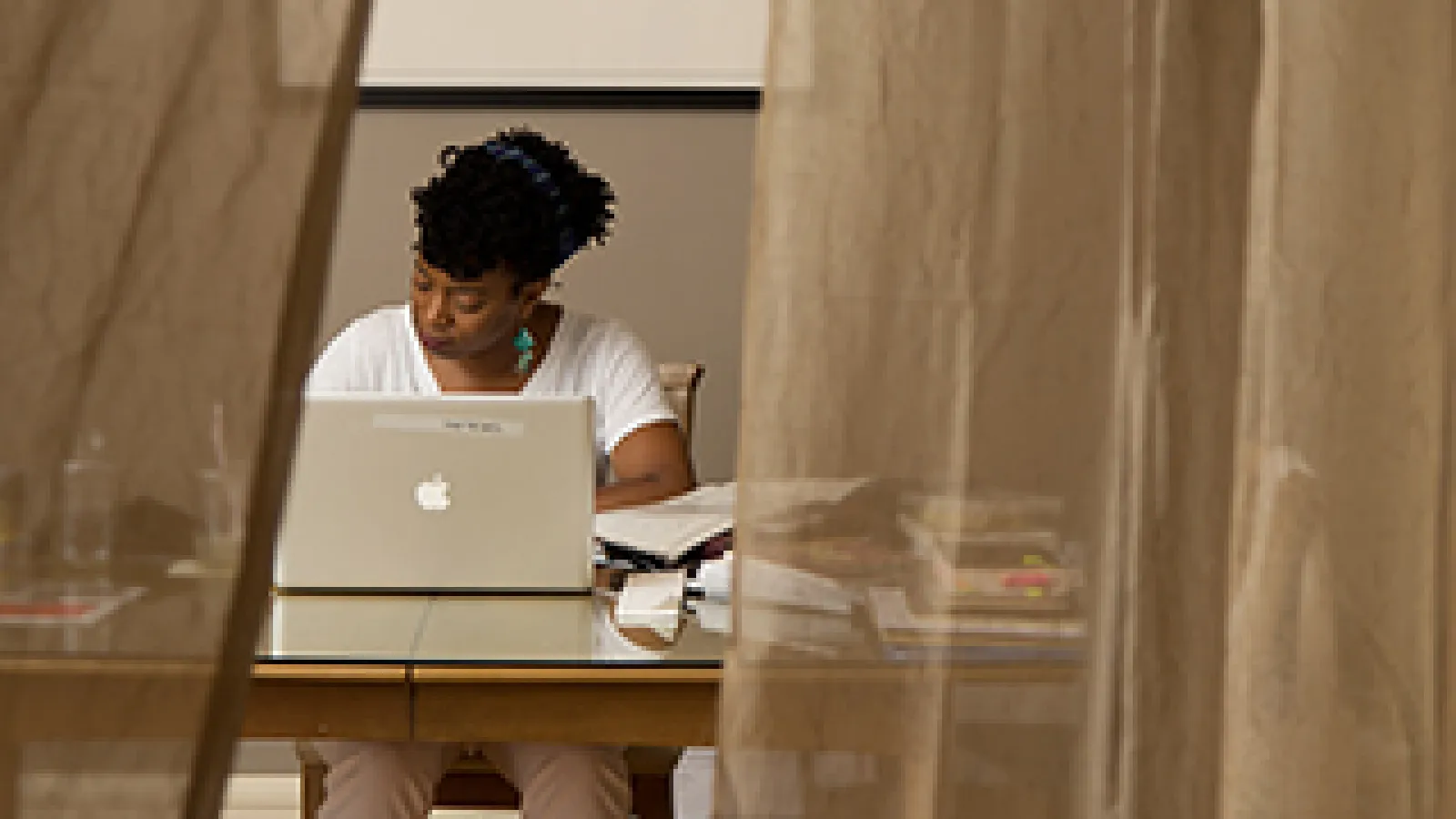 Yona Harvey writing at a desk