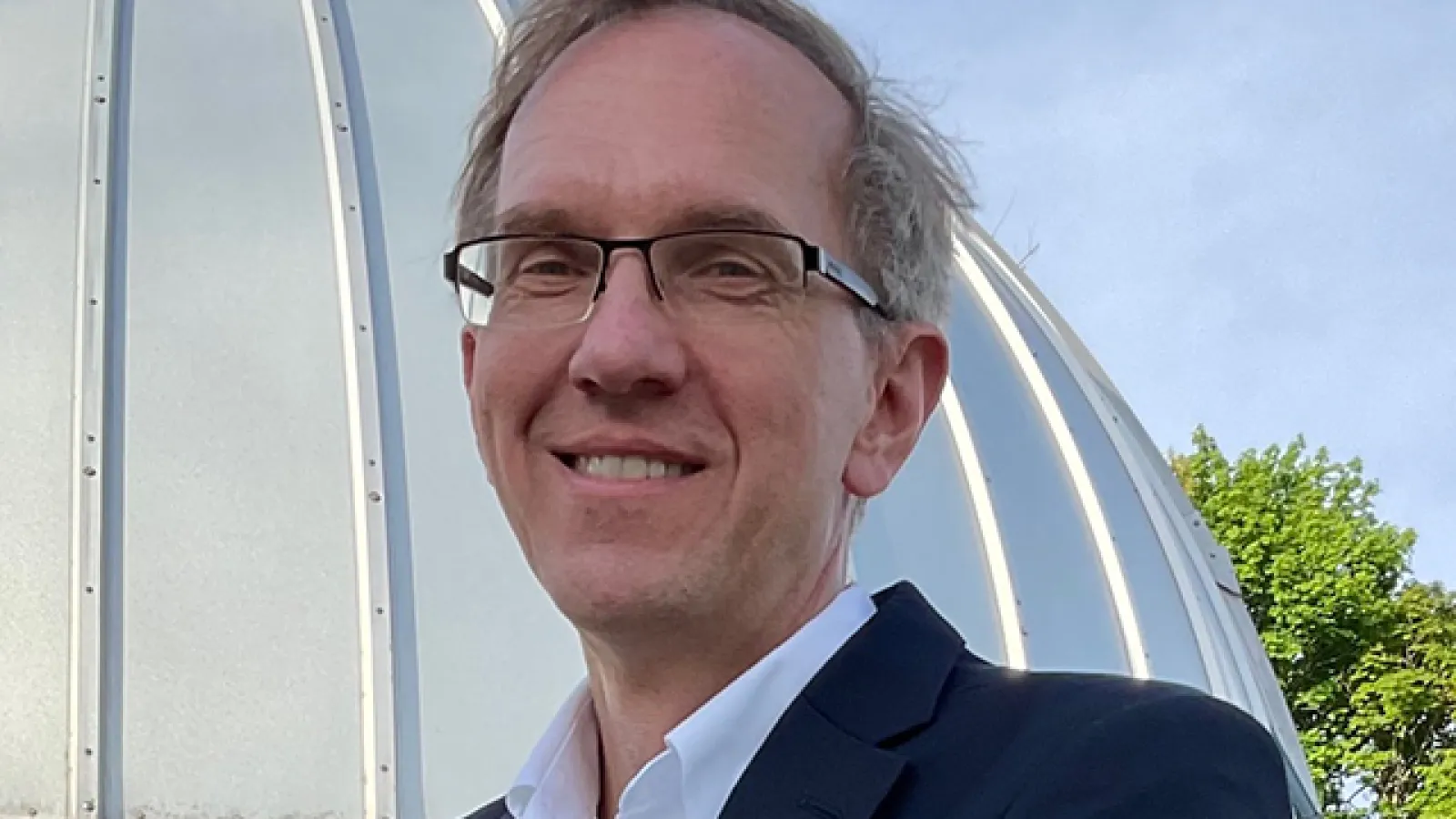 Joseph Shields by the Large Binocular Telescope. Photo courtesy Ann Fidler