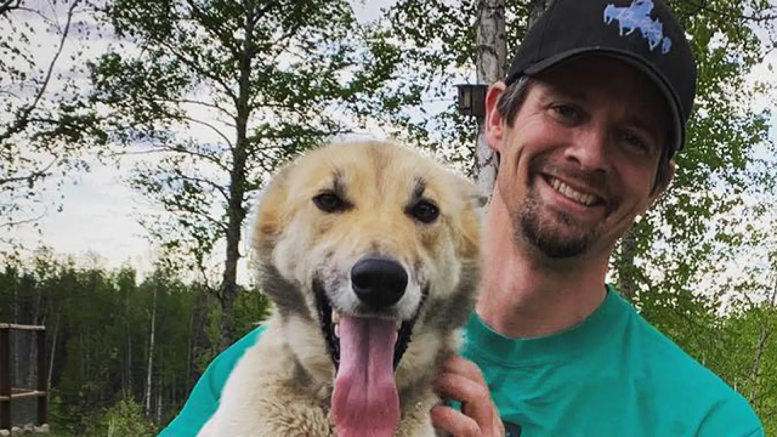 Matthew Failor poses with one of his sled dogs