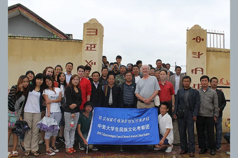 Professor Mark Bender and a group of students pose while visiting a village in Chengdu