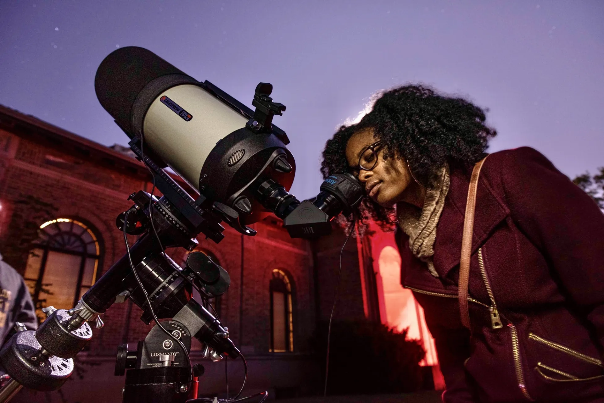 Ohio State PhD candidate Caprice Phillips looking through a telescope