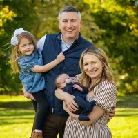Mallory smiles with her husband, daughter and infant son. 